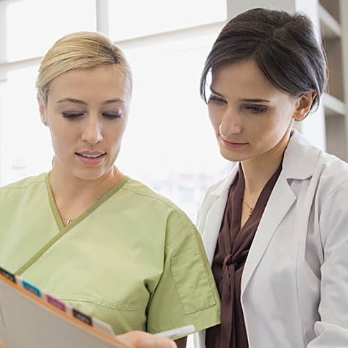 Dental hygienist and doctor looking over documents together