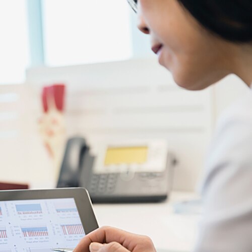 Nurse and doctor looking over a screen with charts