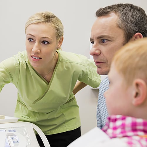 Nurse explaining x-rays to a parent and child