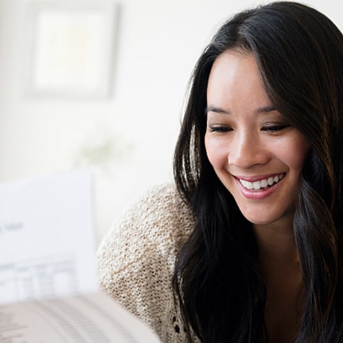Woman smiling while looking over documents