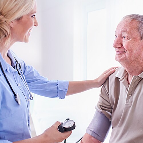 Doctor comforting patient by touching his shoulder