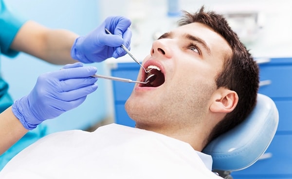 Dentist performing a treating dentin hypersensitivity