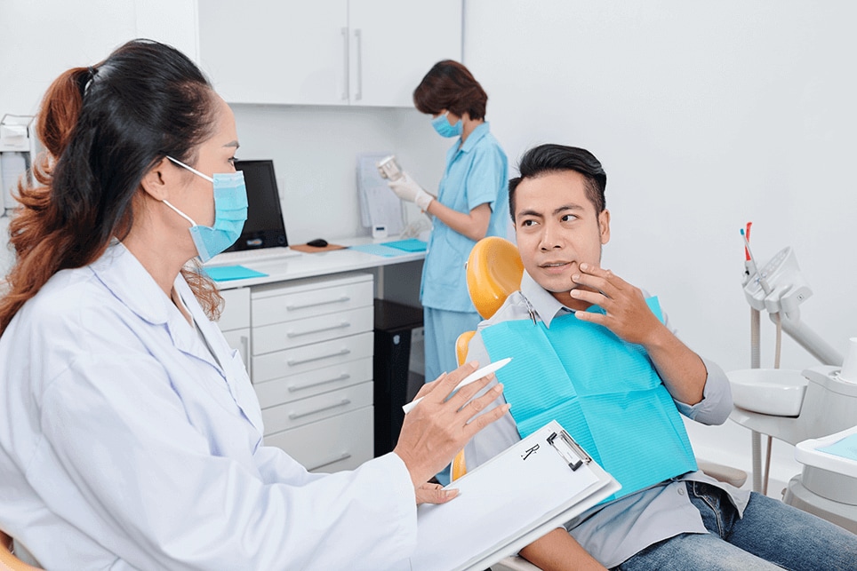 dentist-discussing-toothache-patient-when-nurse