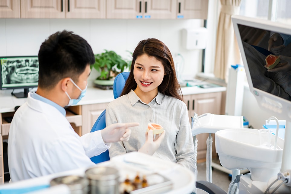 Dentist and patient discussing about oral health