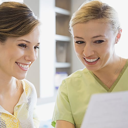 Nurse and patient happily looking over results