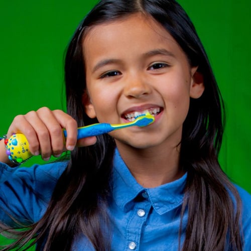 Little girl brushing teeth electric toothbrush