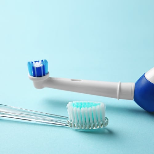 manual-electric-toothbrushes-on-color-background
