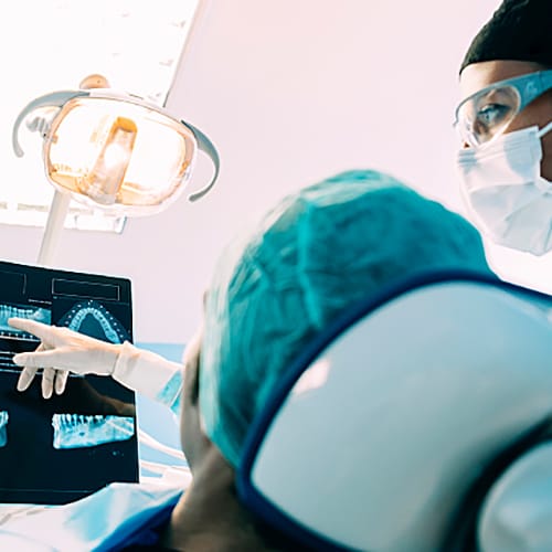 Two dental hygienist explaining x-rays to patient