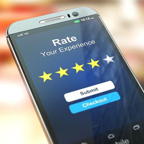 Close-up of phone screen with the words "Rate your experience" with stars and two buttons labeled submit and checkout