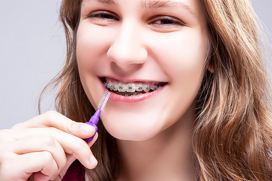teenage-girl-oralcare-bristle-toothbrush-against