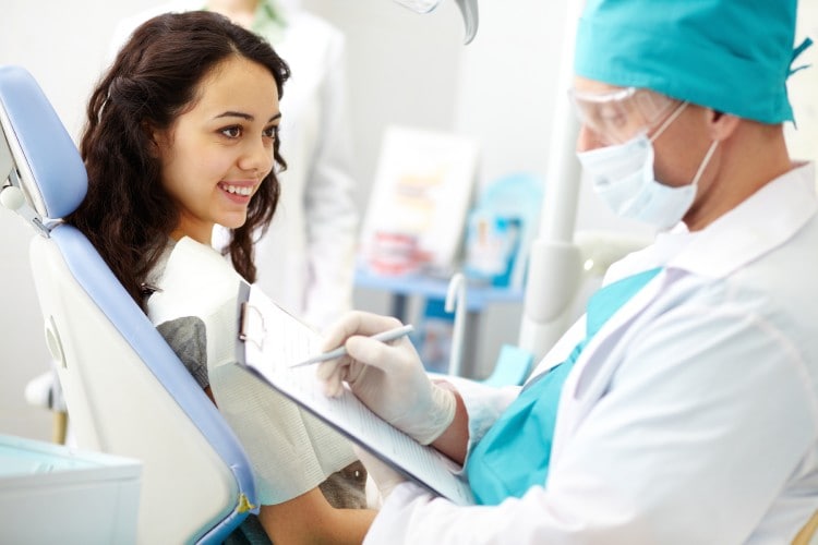 young-female-patient-looking-dentist-while.jpg