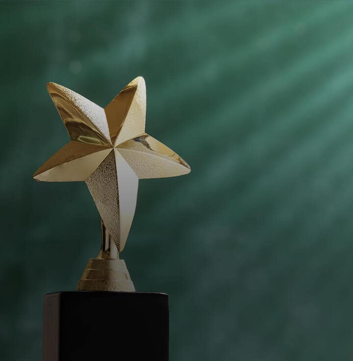 Star trophy with dark wood base and a dark green background