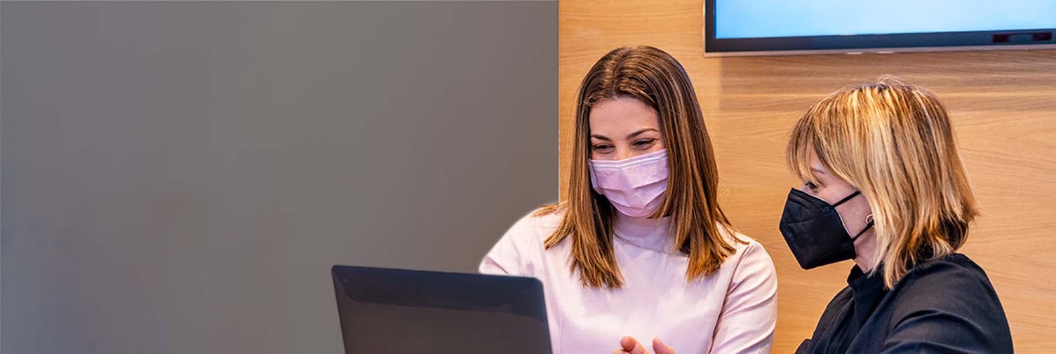 photo of patient watching the dental hygienist as she see the Colgate care plan in her computer