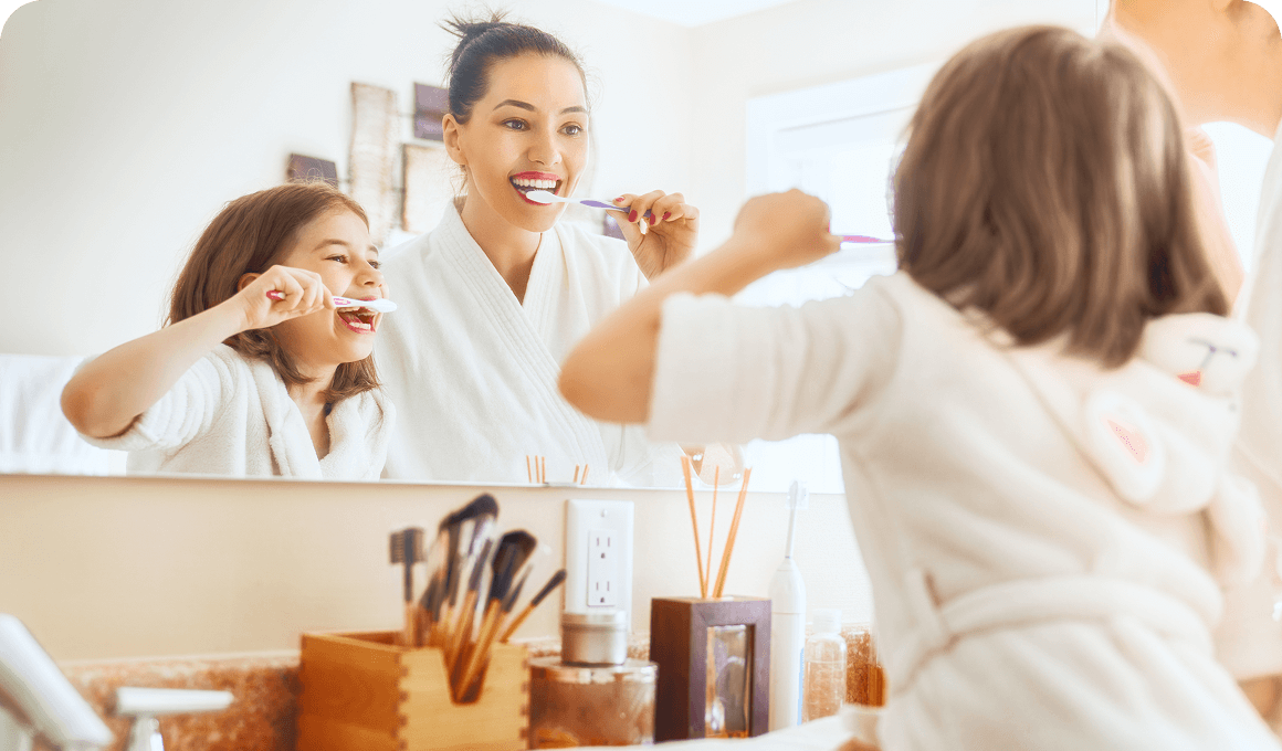 woman and kid brushing their tooth